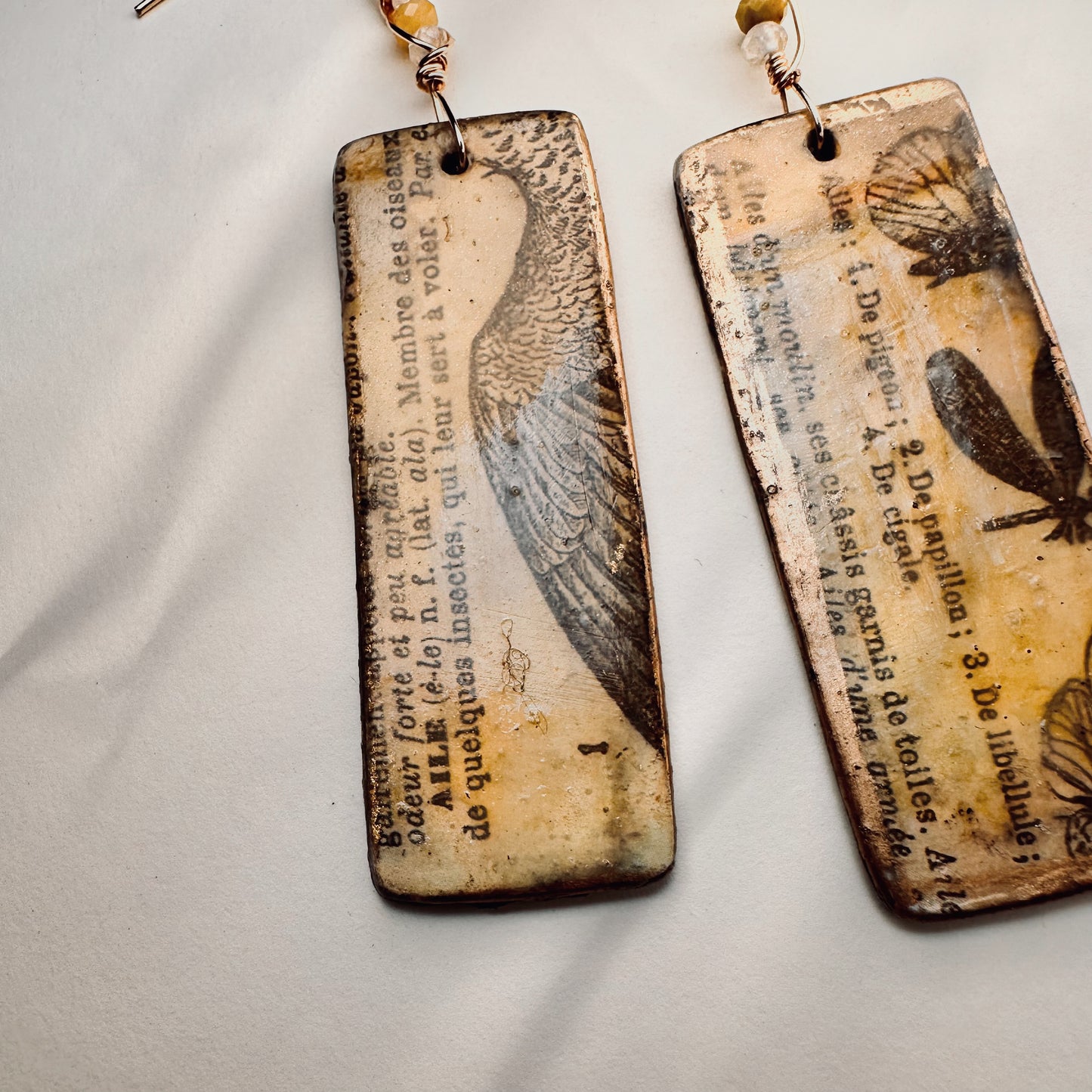 Palimpsest Relic Earrings Aged Text & Wing Motif in Resin & Patina